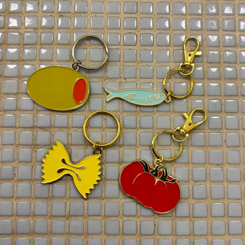 and here we are assorted keychains fish tomato farfalle pasta olive